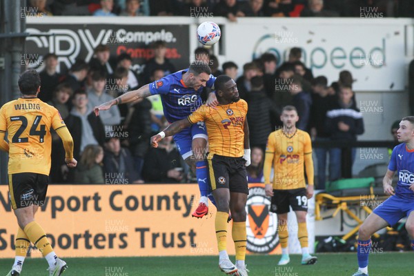 041123 - Newport County v Oldham Athletic - FA Cup First Round - Omar Bogle of Newport County completes with Liam Hogan of Oldham Athletic for a long ball