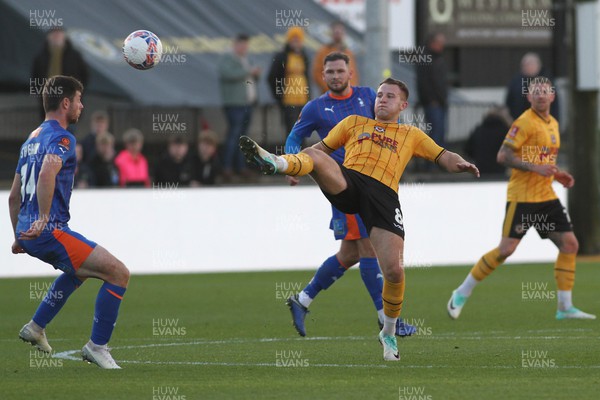 041123 - Newport County v Oldham Athletic - FA Cup First Round - Bryn Morris of Newport County stretches to beat Nathan Sheron of Oldham Athletic to a loose ball