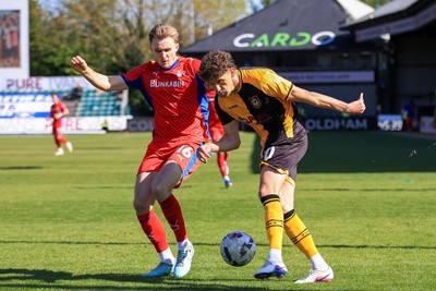 250426 - Newport County v Oldham Athletic - Sky Bet League 2 - Harrison Biggins of Newport County and Will Sutton of Oldham Athletic