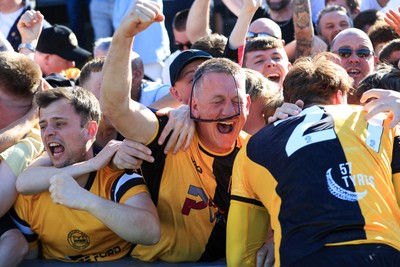 250426 - Newport County v Oldham Athletic - Sky Bet League 2 - Fans celebrate Newport scoring in the 18th minute of injury time to win the match