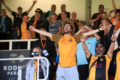 250426 - Newport County v Oldham Athletic - Sky Bet League 2 - Fans celebrate Newport scoring in the 18th minute of injury time to win the match