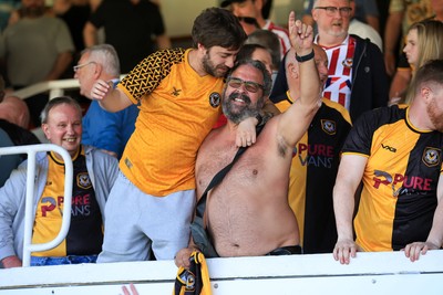 250426 - Newport County v Oldham Athletic - Sky Bet League 2 - Fans celebrate Newport scoring in the 18th minute of injury time to win the match
