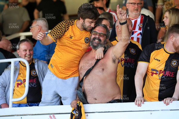 250426 - Newport County v Oldham Athletic - Sky Bet League 2 - Fans celebrate Newport scoring in the 18th minute of injury time to win the match