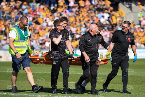 250426 - Newport County v Oldham Athletic - Sky Bet League 2 - Mathew Hudson of Oldham Athletic is carried from the field injured