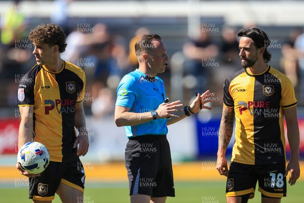 250426 - Newport County v Oldham Athletic - Sky Bet League 2 - Liam Shephard of Newport County, referee David Rock and Harrison Biggins of Newport County