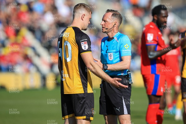 250426 - Newport County v Oldham Athletic - Sky Bet League 2 - Cole Jarvis of Newport County is spoken to by referee David Rock
