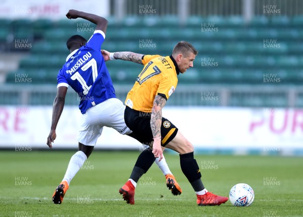 300419 - Newport County v Oldham Athletic - SkyBet League 2 - Scot Bennett of Newport County is tackled by Christopher Missilou of Oldham Athletic