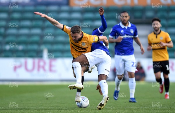 300419 - Newport County v Oldham Athletic - SkyBet League 2 - Dan Butler of Newport County is tackled by Oladapo Afolayan of Oldham Athletic
