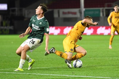 061026 - Newport County v Plymouth Argyle - EFL Trophy - Matt Smith of Newport County is tackled by Tegan Finn of Plymouth in the box and wins his side a penalty