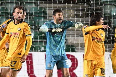 061026 - Newport County v Plymouth Argyle - EFL Trophy - Shaun MacDonald of Newport County saves the penalty from Aribim Pepple of Plymouth to keep the score level