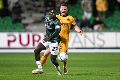 061026 - Newport County v Plymouth Argyle - EFL Trophy - Lee Jenkins of Newport County is challenged by Aribim Pepple of Plymouth
