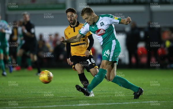131118 - Newport County v Plymouth Argyle, EFL Checkatrade Trophy - Peter Grant of Plymouth Argyle clears as Josh Sheehan of Newport County closes in 