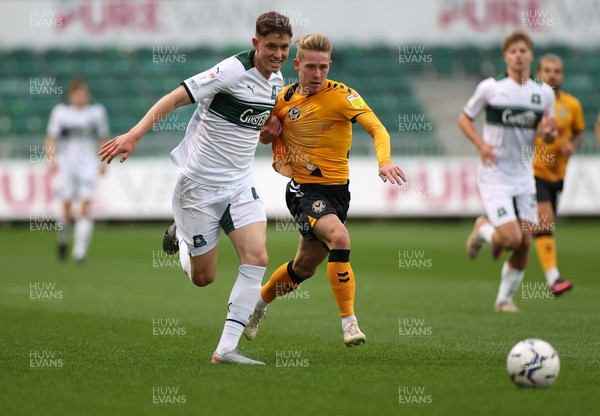 310821 - Newport County v Plymouth Argyle - Papa Johns Trophy - Ollie Cooper of Newport County is challenged by Oliver Tomlinson of Plymouth