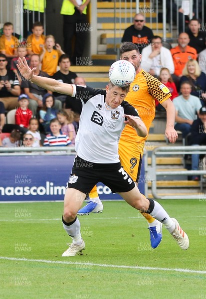 070919 - Newport County v Port Vale, SkyBet League 2 - Adam Crookes of Port Vale is put under pressure by Padraig Amond of Newport County as he heads clear