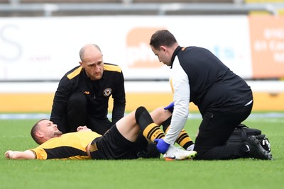 070924 - Newport County v Port Vale - Sky Bet League 2 - Shane McLoughlin of Newport County goes off the field injured