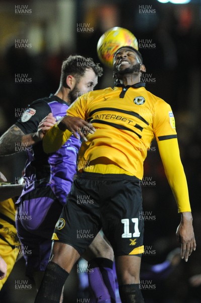 290119 - Newport County v Port Vale - Sky Bet League 2 -   Jamille Matt of Newport County heads on under pressure from Connell Rawlinson of Port Vale