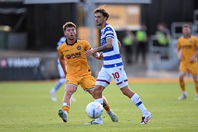 280726 - Newport County v Reading - Preseason Friendly - Cameron Evans of Newport County is challenged by Lewis Wing of Reading