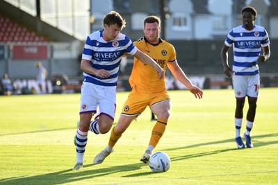 280726 - Newport County v Reading - Preseason Friendly - Lee Jenkins of Newport County is challenged by Ben Ward of Reading
