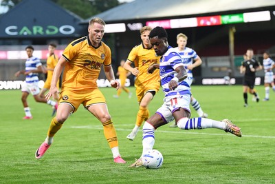 280726 - Newport County v Reading - Preseason Friendly - Cameron Norman of Newport County is challenged by Daniel Kyerewaa of Reading