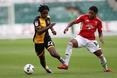 190825 - Newport County v Salford City - SkyBet League Two - Habeeb Ogunneye of Newport County is tackled by Kadeem Harris of Salford City 