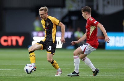 190825 - Newport County v Salford City - SkyBet League Two - Matt Smith of Newport County is challenged by Ben Woodburn of Salford City 