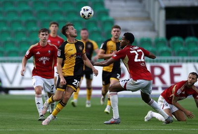 190825 - Newport County v Salford City - SkyBet League Two - Ben Lloyd of Newport County is challenged by Adebola Oluwo of Salford City 