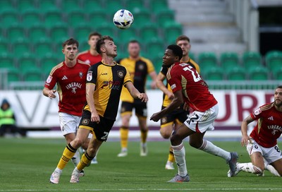 190825 - Newport County v Salford City - SkyBet League Two - Ben Lloyd of Newport County is challenged by Adebola Oluwo of Salford City 