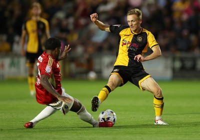 190825 - Newport County v Salford City - SkyBet League Two - Matt Smith of Newport County is tackled by Kadeem Harris of Salford City 
