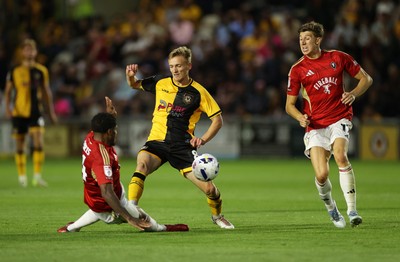 190825 - Newport County v Salford City - SkyBet League Two - Matt Smith of Newport County is tackled by Kadeem Harris of Salford City 