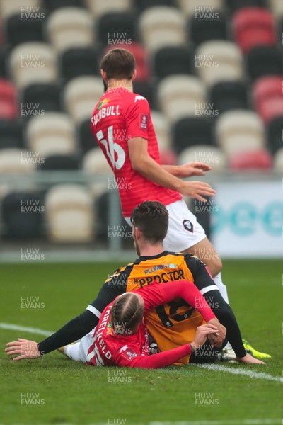 281120 - Newport County v Salford City - FA Cup Second Round - Jamie Proctor of Newport County tangles with Jordan Turnbull and Oscar Threlkeld of Salford City     