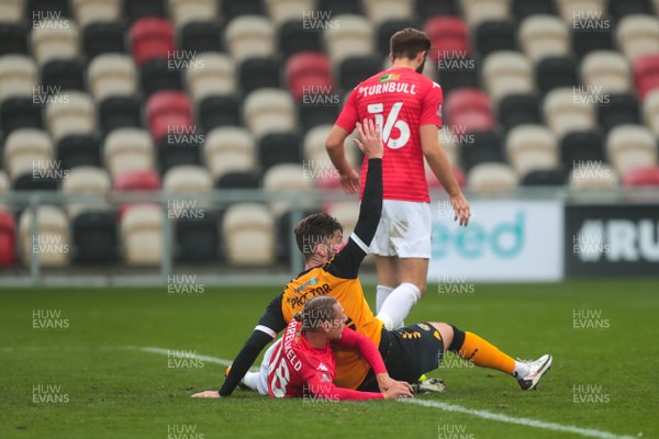 281120 - Newport County v Salford City - FA Cup Second Round - Jamie Proctor of Newport County appeals after a  tangle with Jordan Turnbull and Oscar Threlkeld of Salford City    