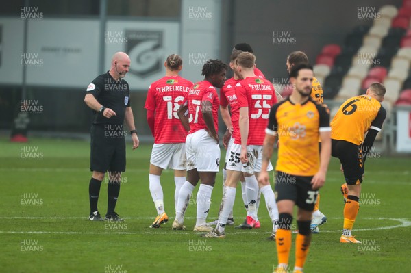 281120 - Newport County v Salford City - FA Cup Second Round - Referee Kevin Johnson speaks to the Salford City players after sending Brandon Thomas-Asante off 