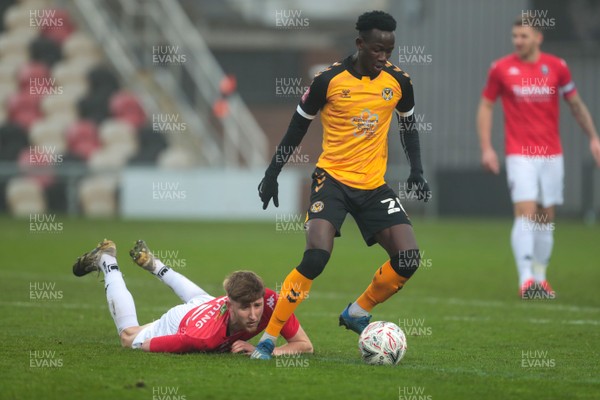 281120 - Newport County v Salford City - FA Cup Second Round - Saikou Janneh of Newport County beats Luke Armstrong of Salford City and heads for goal 