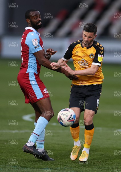 270421 - Newport County v Scunthorpe United - SkyBet League Two - Padraig Amond of Newport County is tackled by Emmanuel Onariase of Scunthorpe