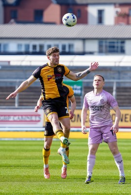 280326 - Newport County v Shrewsbury Town - Sky Bet League 2 - Cameron Evans of Newport County contends for the aerial ball with Anthony Scully of Shrewsbury Town