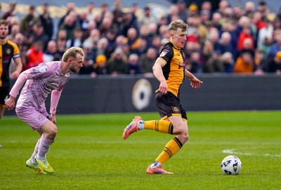 280326 - Newport County v Shrewsbury Town - Sky Bet League 2 - Sven Sprangler of Newport County passes the ball whilst under pressure from Taylor Perry of Shrewsbury Town