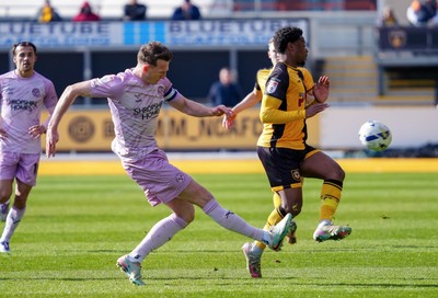 280326 - Newport County v Shrewsbury Town - Sky Bet League 2 - William Boyle of Shrewsbury Town clears the ball whilst under pressure from Bobby Kamwa of Newport County