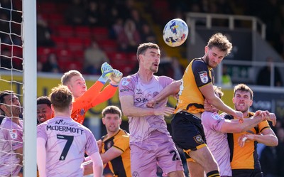 280326 - Newport County v Shrewsbury Town - Sky Bet League 2 - Matthew Cox of Shrewsbury Town punches the ball clear whilst under pressure from Matthew Baker of Newport County