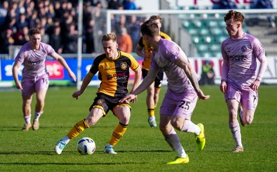 280326 - Newport County v Shrewsbury Town - Sky Bet League 2 - Matt Smith of Newport County runs with the ball whilst under pressure from Josh Ruffels of Shrewsbury Town