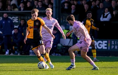 280326 - Newport County v Shrewsbury Town - Sky Bet League 2 - Tom Davies of Newport County runs with the ball whilst under pressure from Taylor Perry and Sam Clucas of Shrewsbury Town