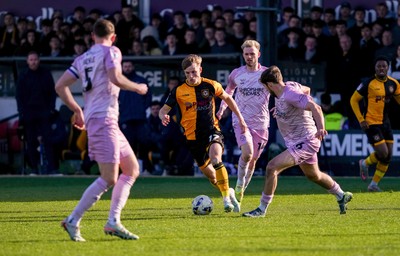 280326 - Newport County v Shrewsbury Town - Sky Bet League 2 - Tom Davies of Newport County runs with the ball whilst under pressure from Taylor Perry and Sam Clucas of Shrewsbury Town