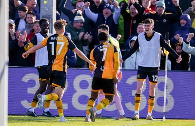 280326 - Newport County v Shrewsbury Town - Sky Bet League 2 - Bobby Kamwa of Newport County celebrates scoring his team’s first goal with teammates Tom Davies and Joe Thomas
