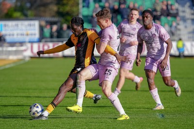 280326 - Newport County v Shrewsbury Town - Sky Bet League 2 - Nathan Opoku of Newport County is challenged by Josh Ruffels of Shrewsbury Town
