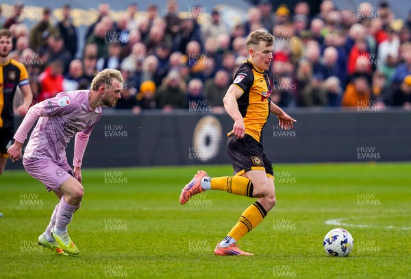 280326 - Newport County v Shrewsbury Town - Sky Bet League 2 - Sven Sprangler of Newport County passes the ball whilst under pressure from Taylor Perry of Shrewsbury Town
