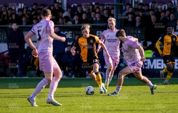 280326 - Newport County v Shrewsbury Town - Sky Bet League 2 - Tom Davies of Newport County runs with the ball whilst under pressure from Taylor Perry and Sam Clucas of Shrewsbury Town