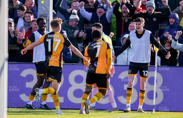 280326 - Newport County v Shrewsbury Town - Sky Bet League 2 - Bobby Kamwa of Newport County celebrates scoring his team’s first goal with teammates Tom Davies and Joe Thomas