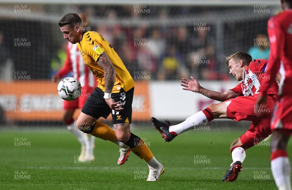 250821 - Newport County v Southampton - Carabao Cup - Scot Bennett of Newport County gets away from James Ward-Prowse of Southampton