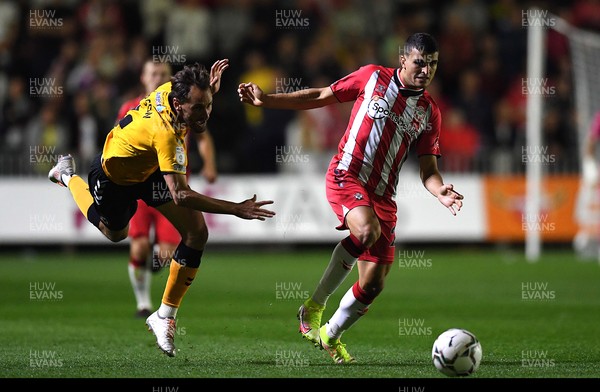 250821 - Newport County v Southampton - Carabao Cup - Mohamed Elyounoussi of Southampton is tackled by Edward Upson of Newport County