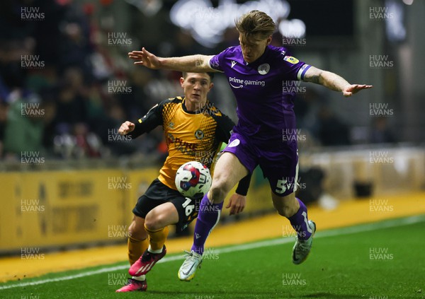 140223 - Newport County v Stevenage, EFL Sky Bet League 2 - Carl Piergianni of Stevenage and Calum Kavanagh of Newport County compete for the ball