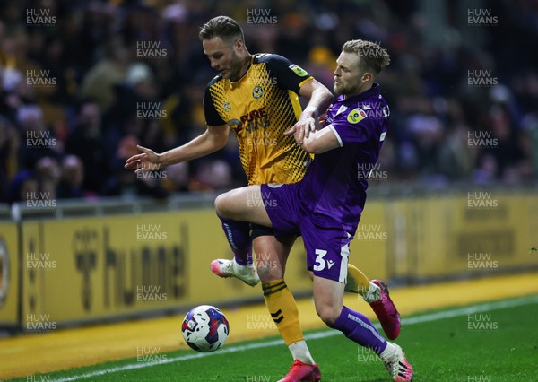 140223 - Newport County v Stevenage, EFL Sky Bet League 2 - Cameron Norman of Newport County is challenged by Max Clark of Stevenage
